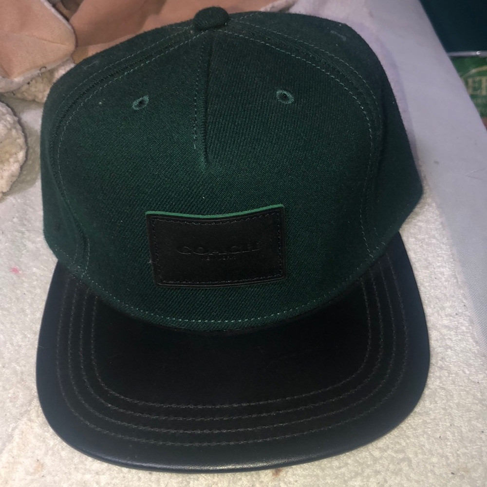 a men’s Coach hat  it’s green and black leather
